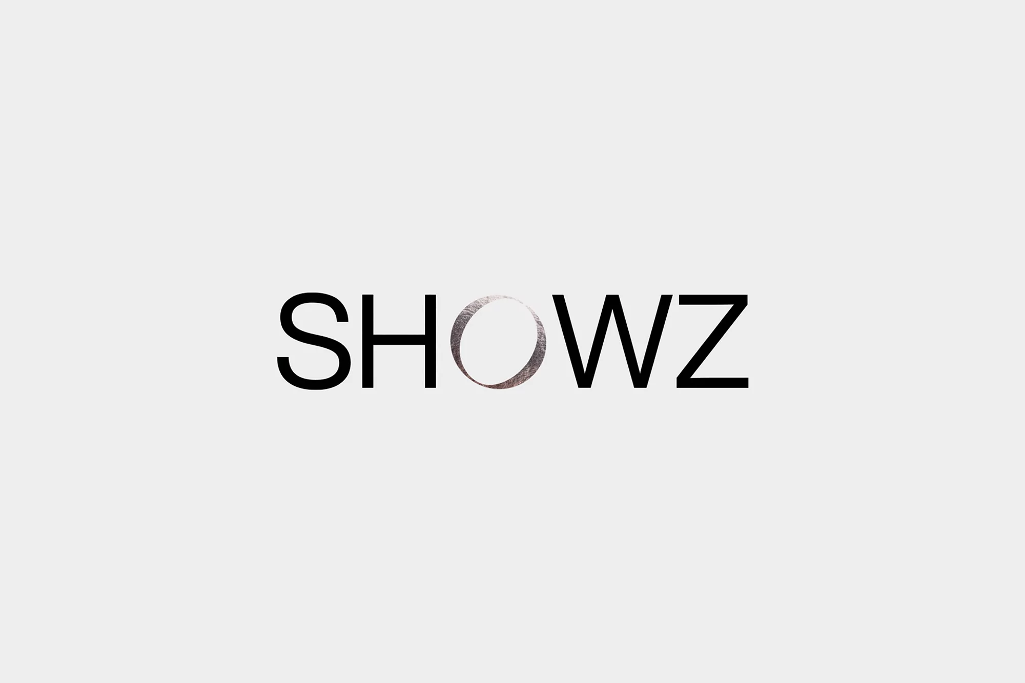SHOWZ logo against a white background with a silver circle replacing the 'O'. Modern, minimalist brand identity.