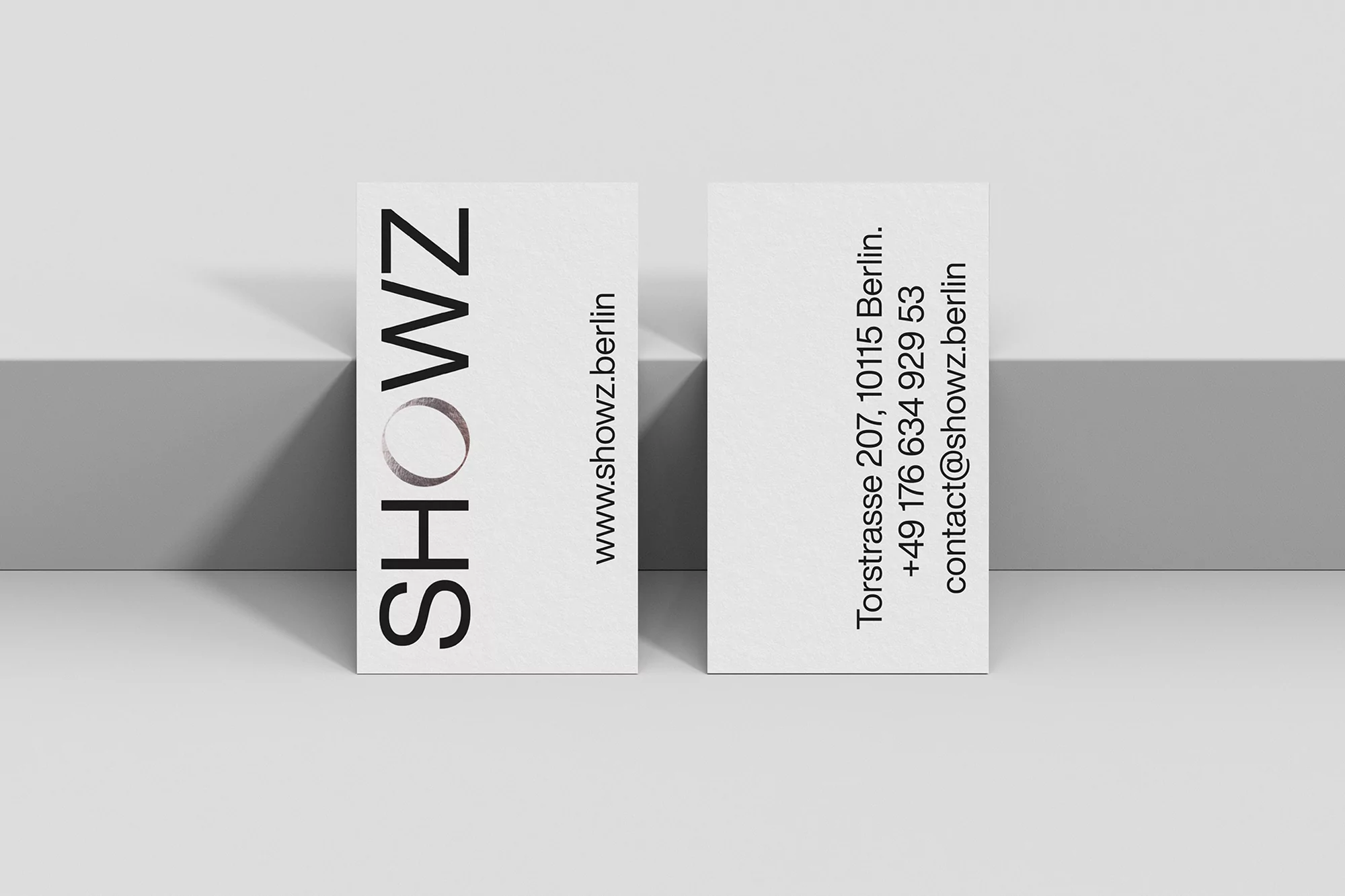 Two business cards from SHOWZ on white background, featuring company branding, contact details, and minimalist design elements.