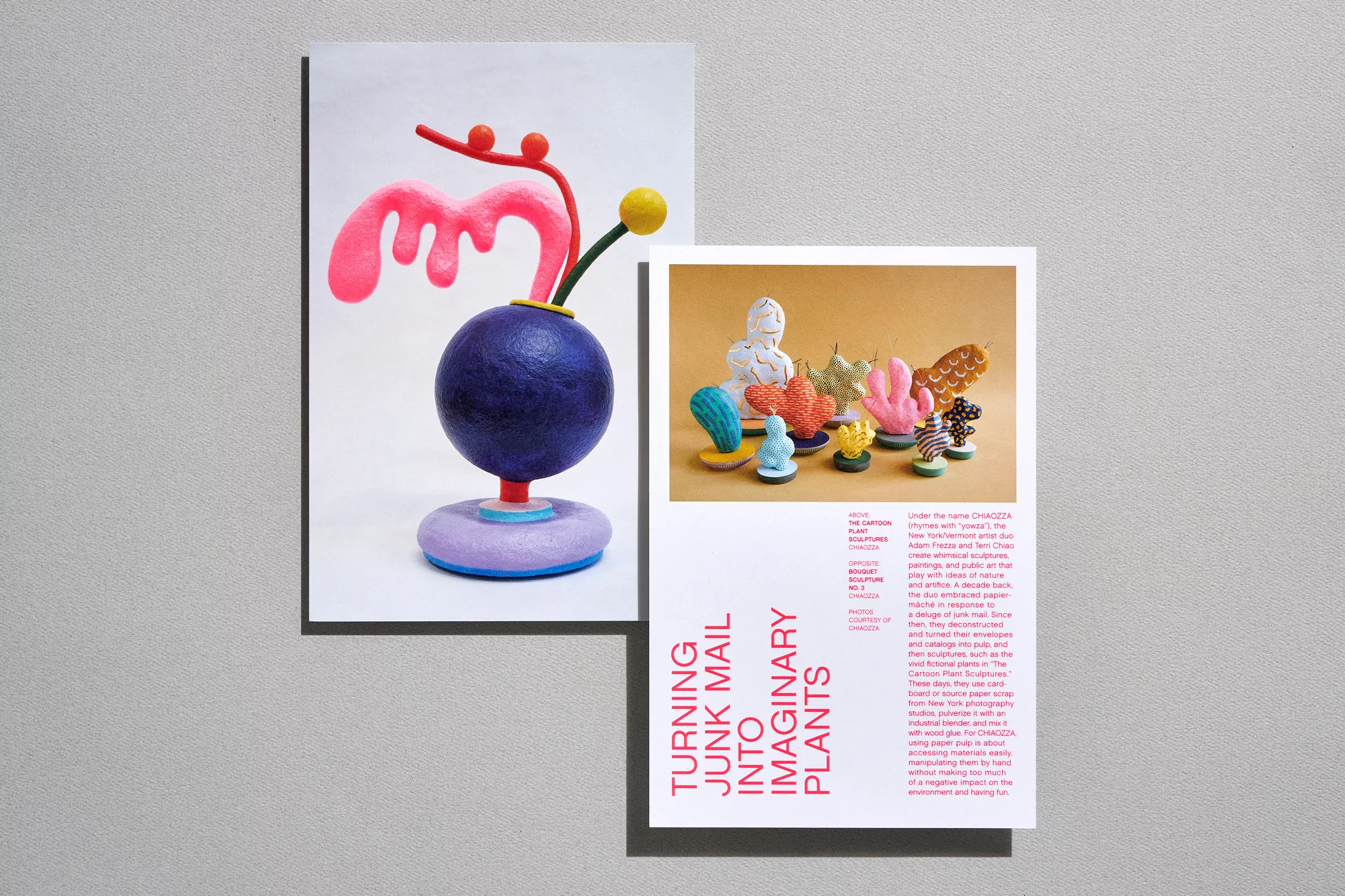 Colorful art installation featuring abstract plant sculptures in pink, blue, purple, and yellow, photographed in a studio setting.