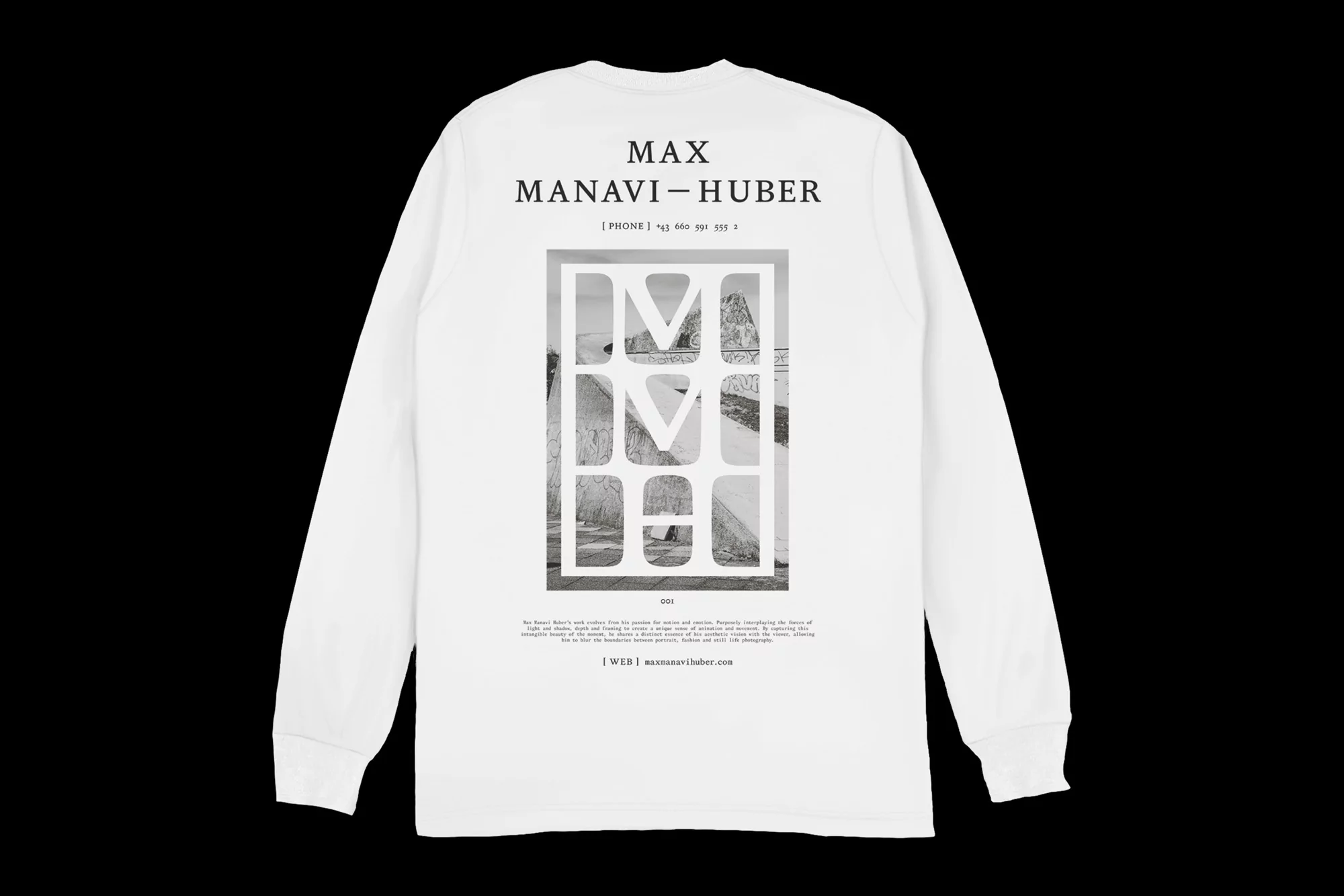 White long-sleeve shirt with a graphic print of a landscape and the text 'MAX MANAVI-HUBER' on the back against a black background.