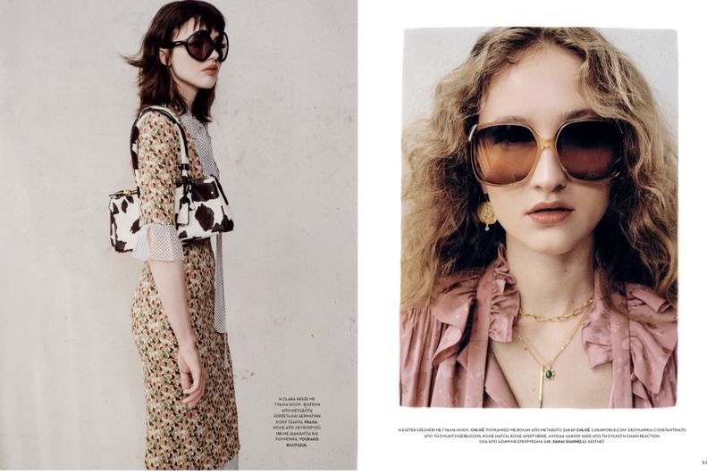 Fashion editorial shot featuring two women wearing sunglasses, dresses, and jewelry. One model carries a handbag in an indoor setting.