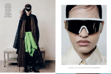 Model wearing dark visor sunglasses and patterned coat in a Vogue Greece editorial spread captured by Antonio Dicorato