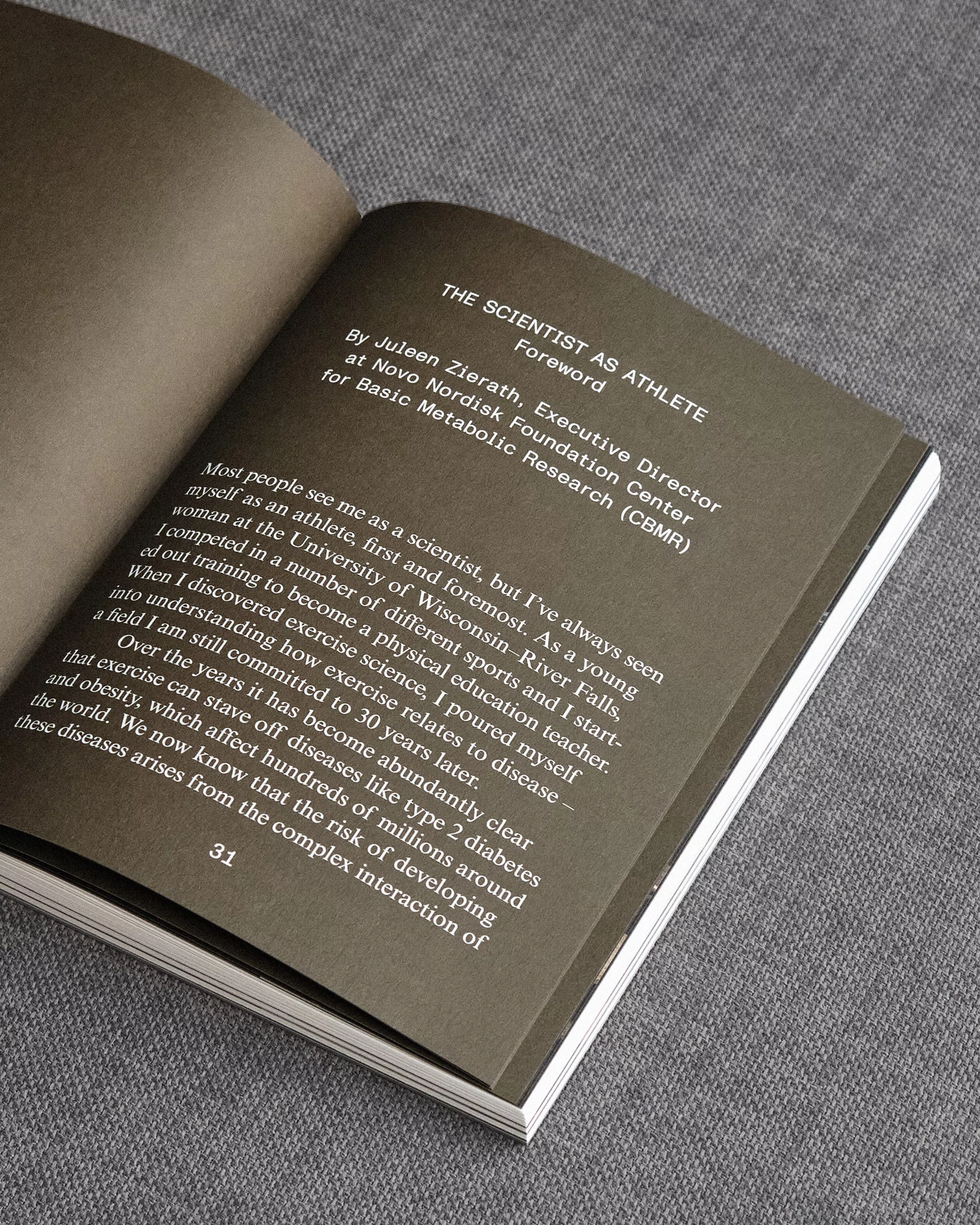 Open book showing a page with text titled 'The Scientist as Athlete'. Text details the author's background as a scientist and athlete.