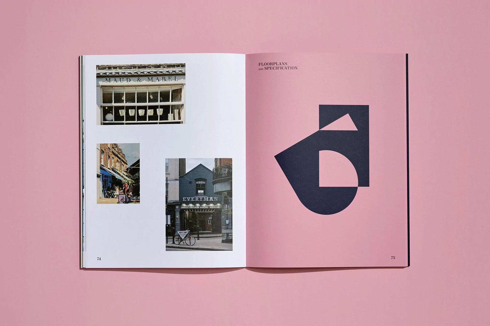 Open book displays photographs of building exteriors and an abstract graphic design on a pink background, showcasing architectural photography.