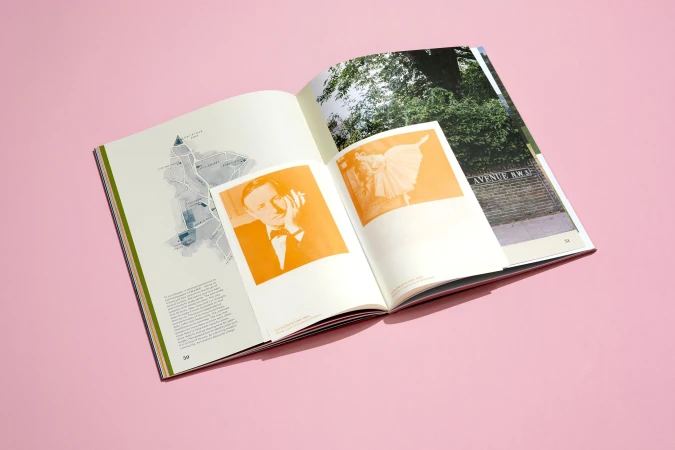 Open magazine displays vintage photos, a street map, and an 'Avenue Away' street scene on a pink backdrop, with text on adjacent pages.