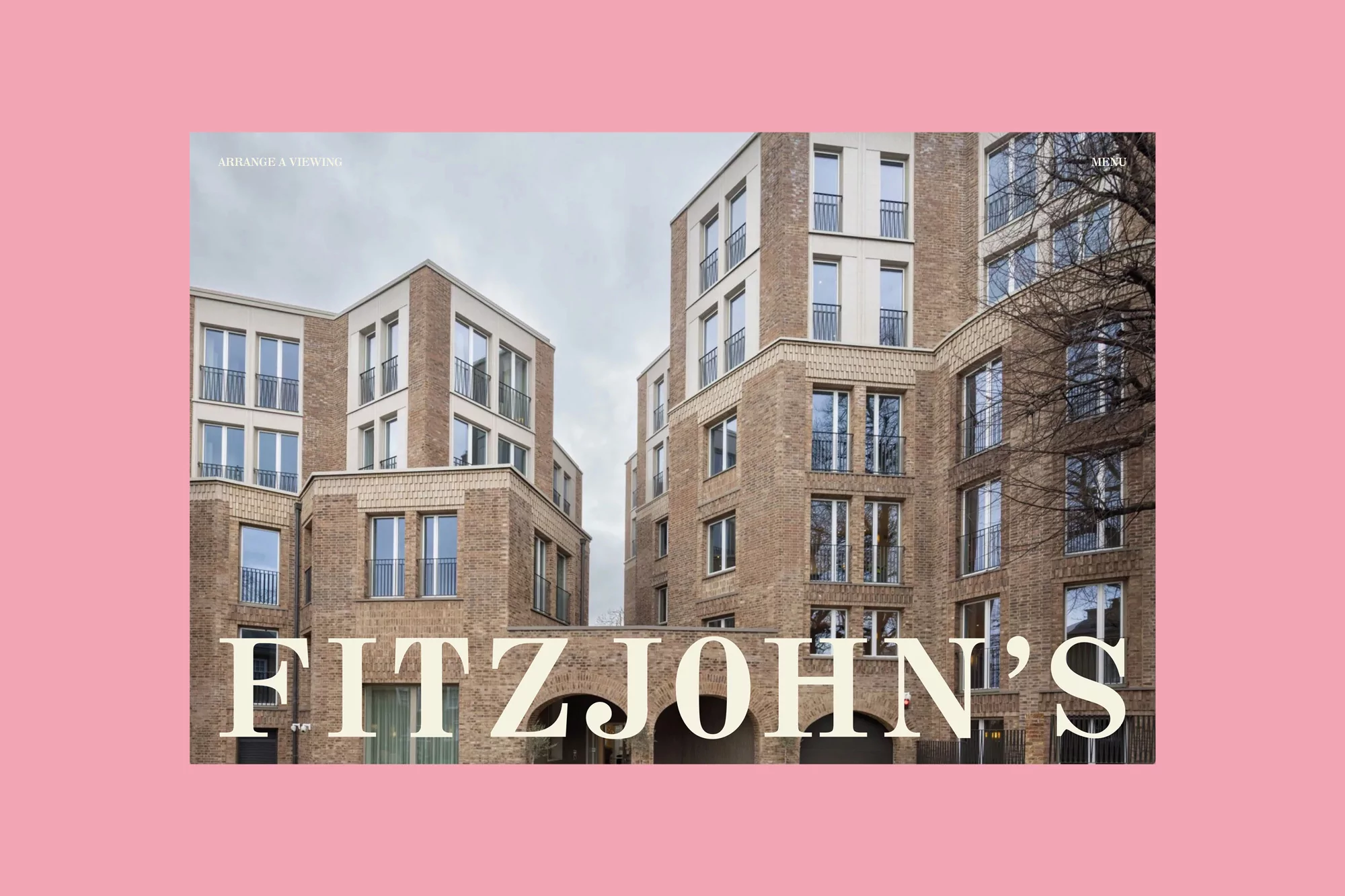Exterior view of a modern brick apartment complex under a cloudy sky, framed by a pink border and featuring bold 'FITZJOHN'S' text.