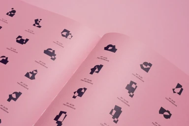 Open pink booklet displaying a grid of black abstract graphic symbols and apartment numbering typography.