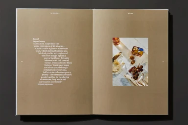 Open brochure pages with brown paper background, typography on the left, and a food photograph on the right.