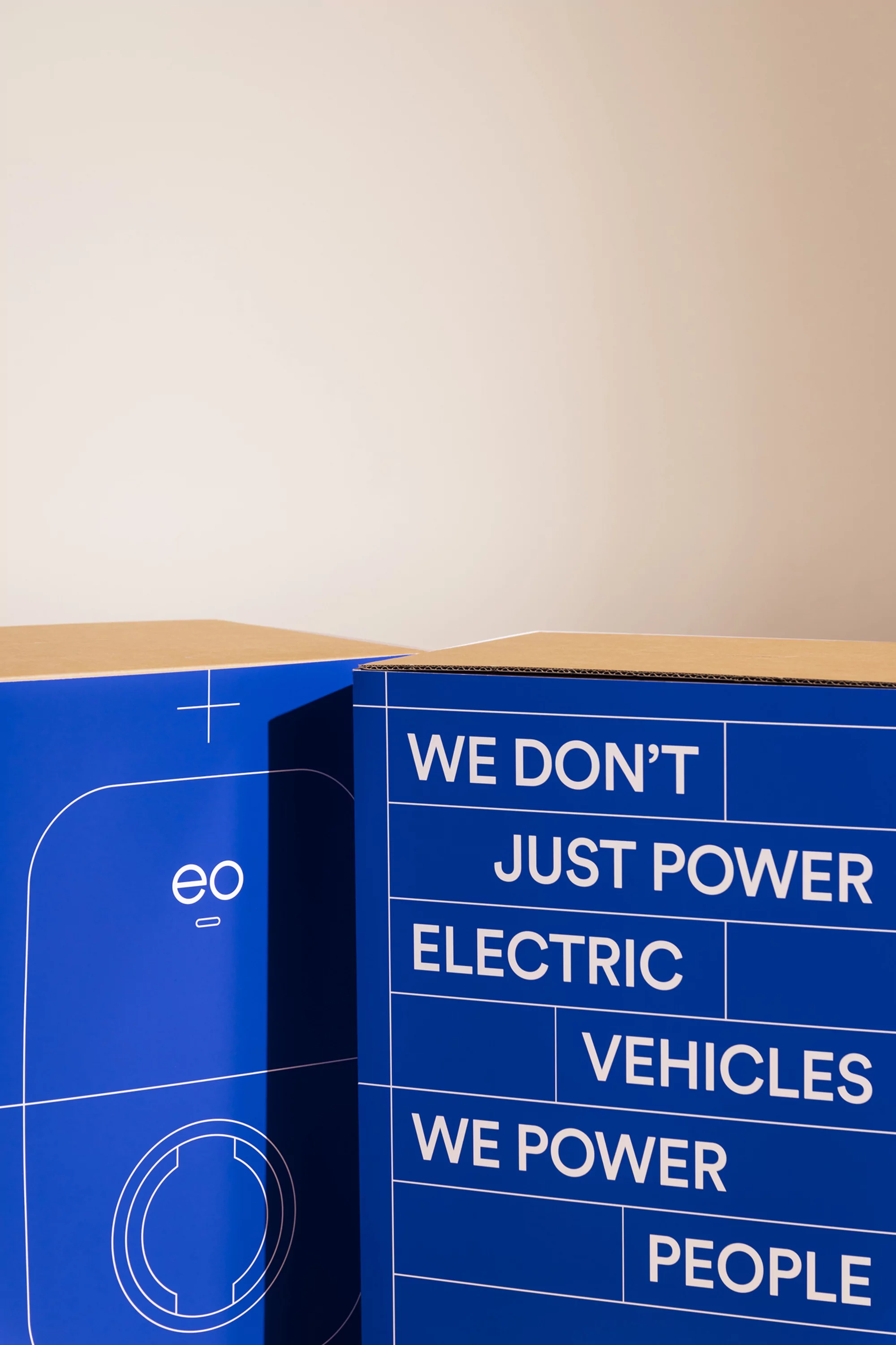 Two boxes feature electric vehicle charging station graphics and text 'We don't just power electric vehicles, we power people'.