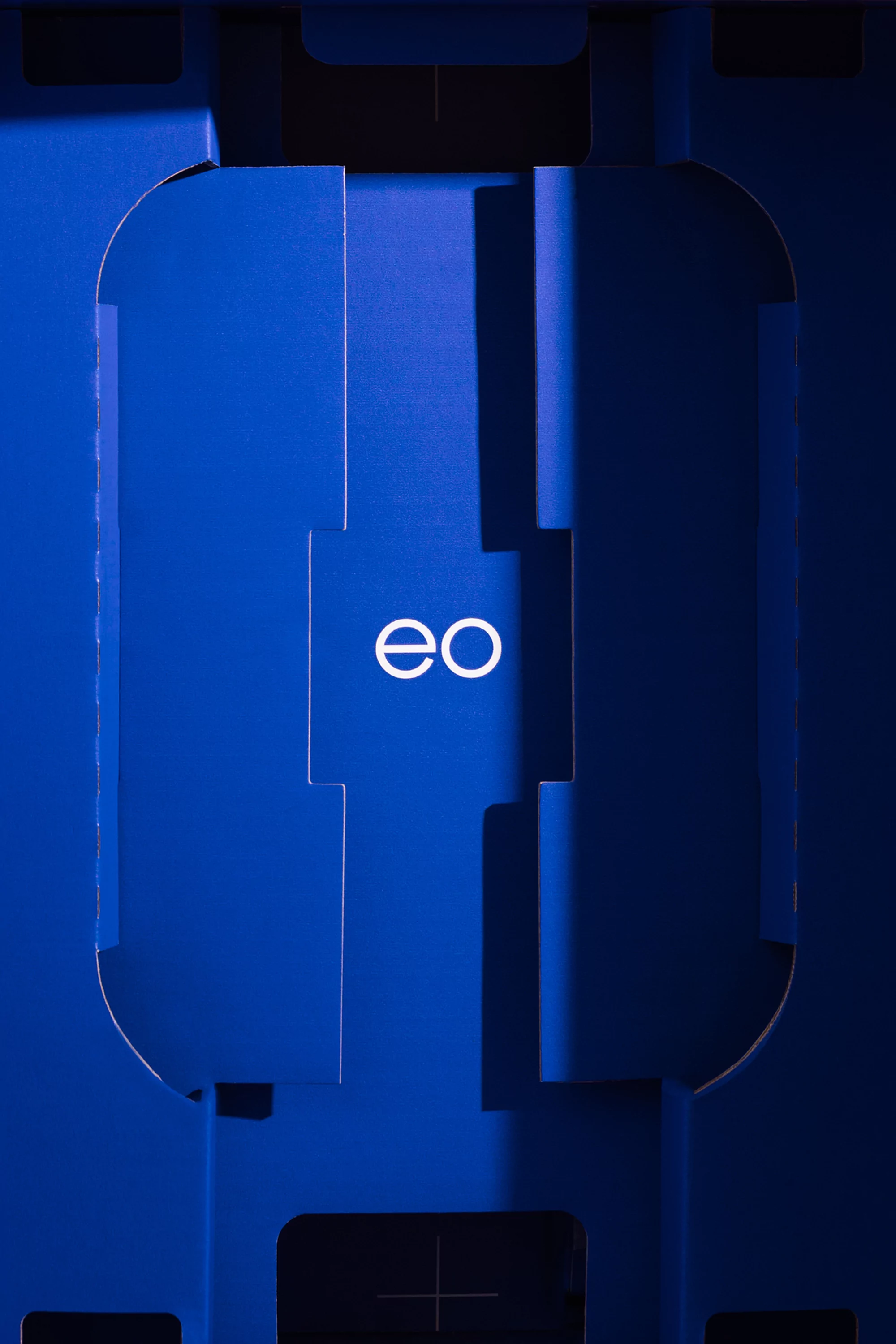Close-up of a blue dimensional geometric design with the white logo 'eo' in the center, highlighting modern abstract art.