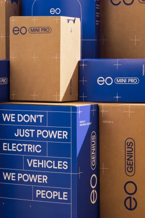 Stacked product boxes for EO Mini Pro, featuring bold typography, electric vehicle focus, and a blue and brown color scheme.
