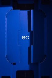Blue branded packaging box with white typography logo for EO on a dark surface