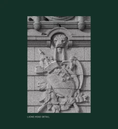 Monochrome architectural detail showing stone carved lion head and crest framed within a dark green border with text caption.