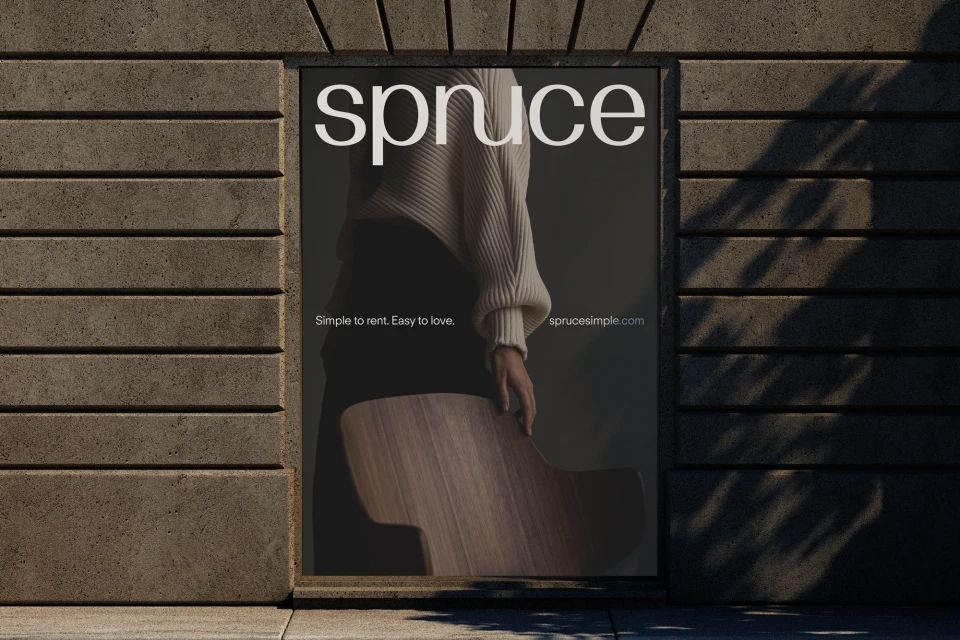 Outdoor advertising poster featuring a person in knitwear and chair, highlighting Spruce rental services and modern design aesthetic.