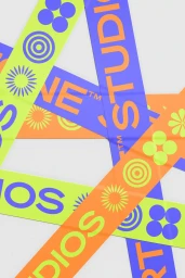Overlapping colorful bands featuring typographic branding and geometric shapes on white background