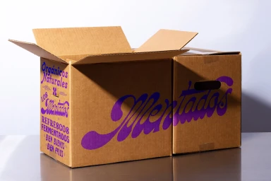 Open cardboard shipping box with purple custom branding typography against a clean studio background