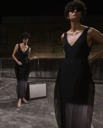Two models in black dresses and sunglasses on a rooftop concrete surface with an amplifier for Deering Collection 02