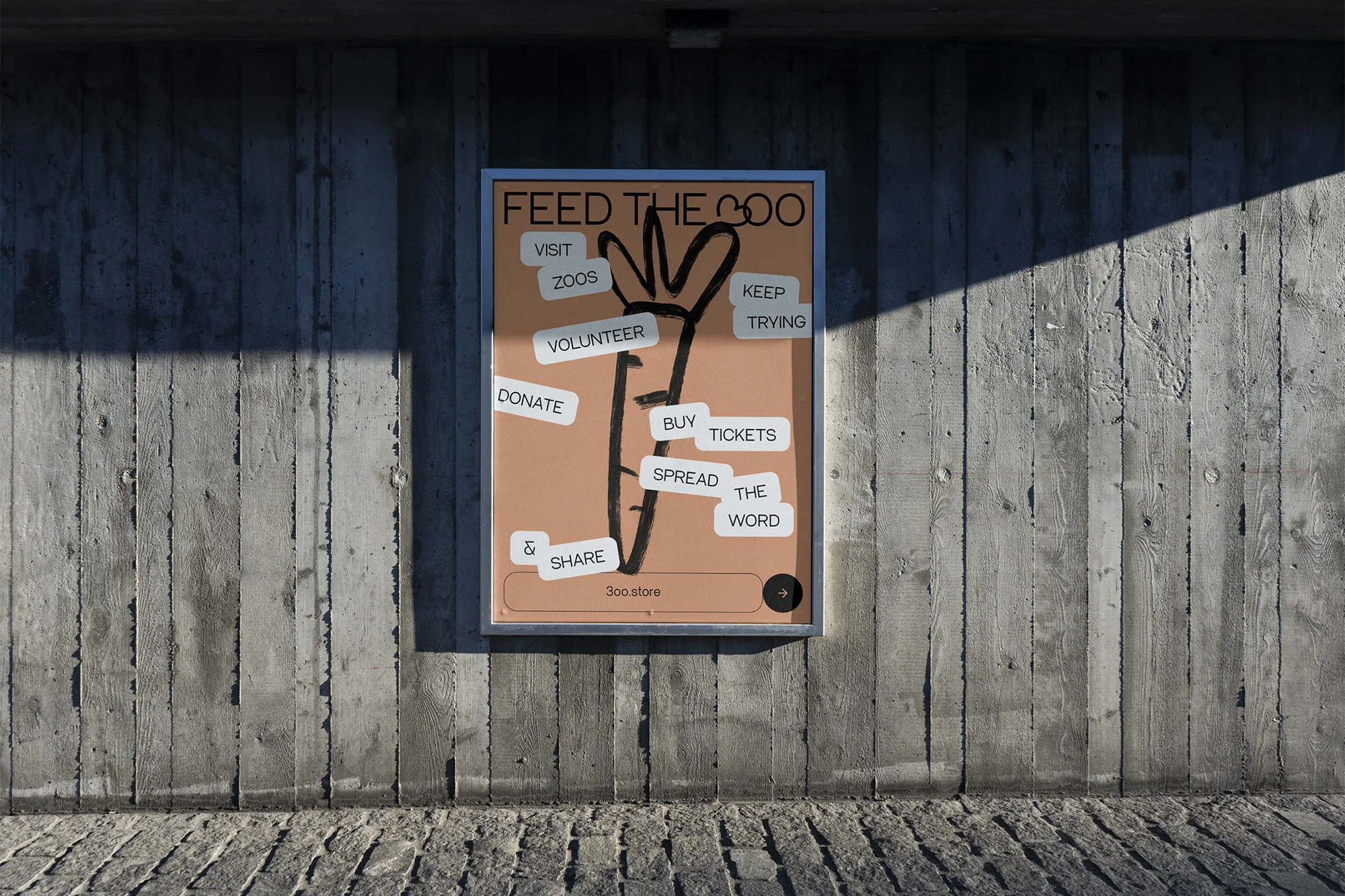 Framed graphic ad featuring a drawing of a carrot with text overlays on a concrete wall and stone sidewalk. Outdoor location.