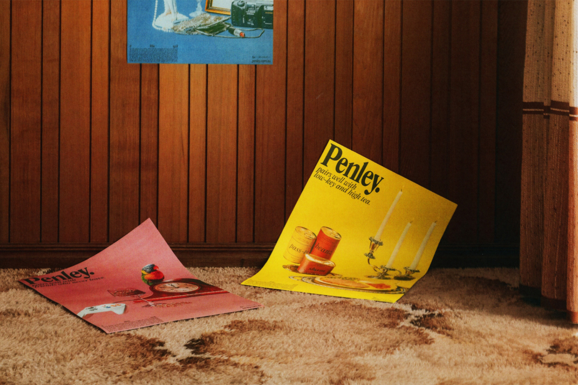 Retro-style product posters on a vintage carpet with a wood-panel wall, evoking a sense of nostalgia and old-fashioned advertising.