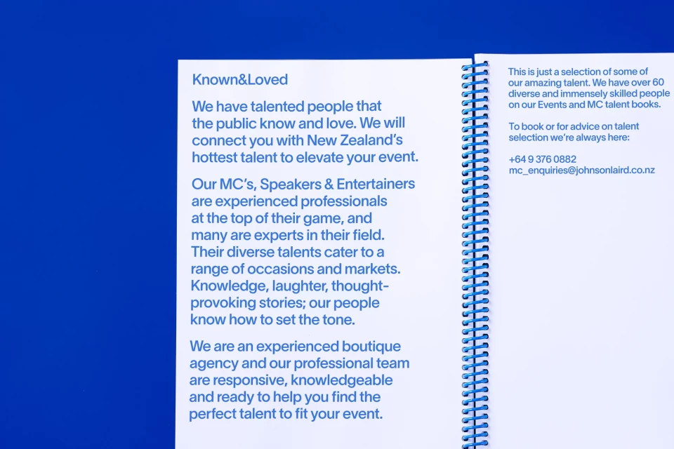 Marketing material on a white spiral-bound notebook, featuring event talent booking services with talent, speaker, and entertainer information.