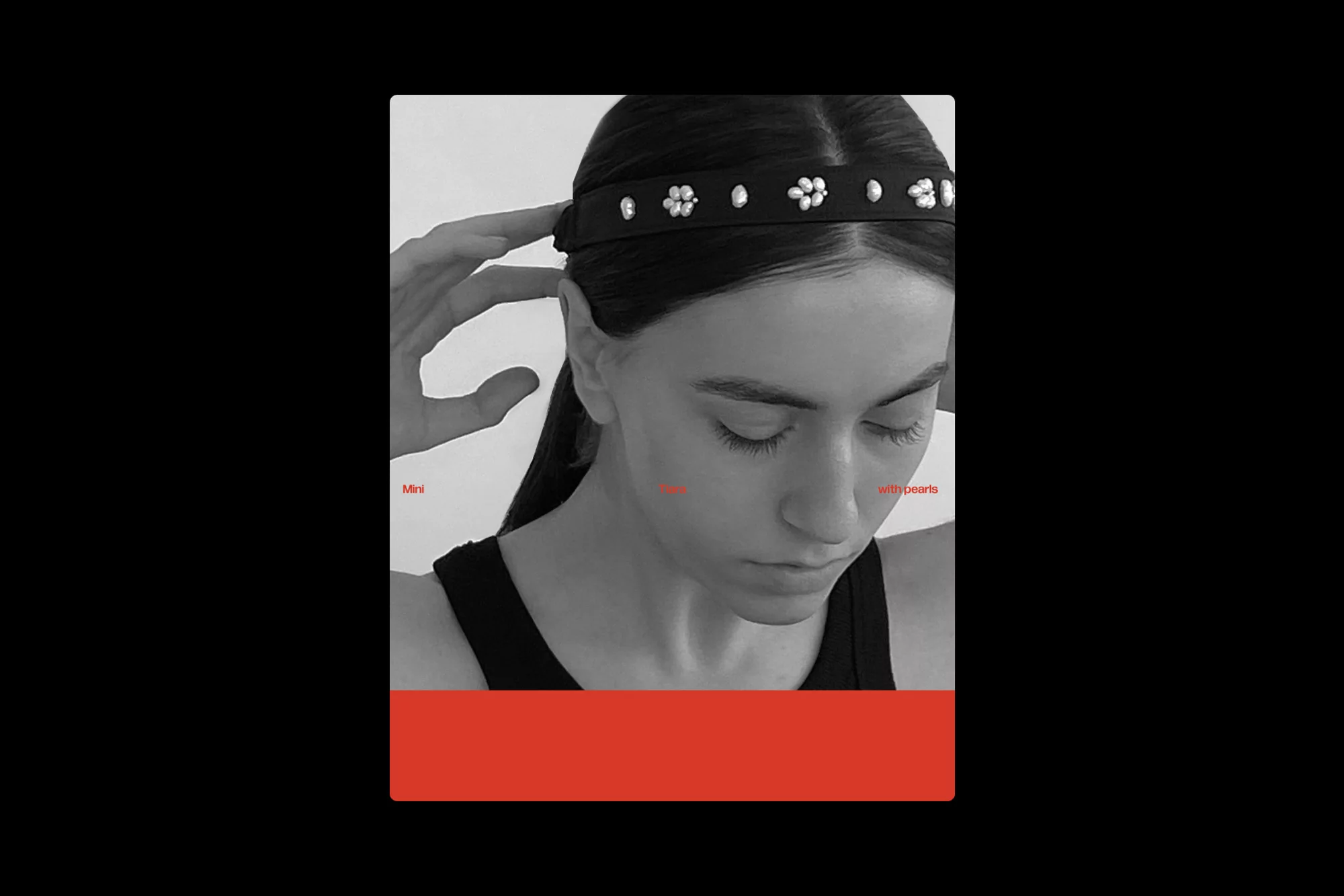 A woman adjusts a pearl-studded black headband in a black and white portrait with a red bar at the bottom of the frame.