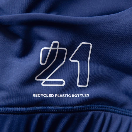 Close-up of navy blue athletic apparel with a white '21' graphic and the text 'Recycled Plastic Bottles' indicating sustainability.
