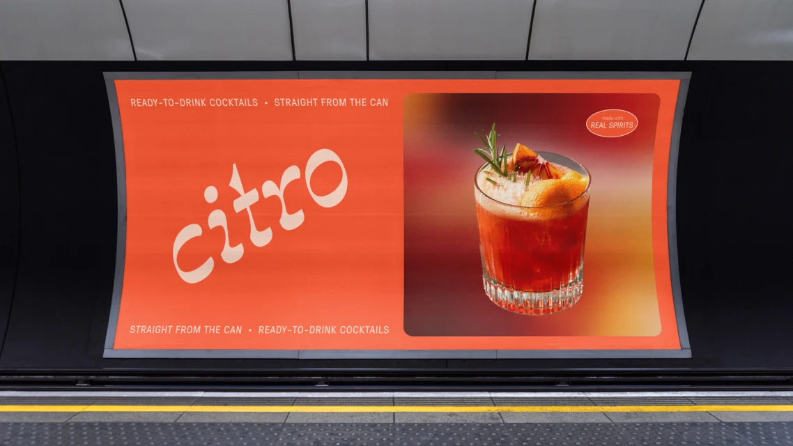 Advertising billboard displaying 'Citro' canned cocktails. An orange cocktail garnished with rosemary appears on the right side.