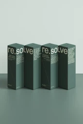 Four dark green rectangular skincare packaging boxes arranged in a row on a grey surface against a pale wall.