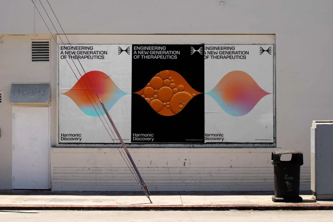 Outdoor posters on a white wall showcase a new generation of therapeutics with colorful abstract shapes and minimalist typography.