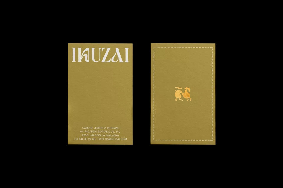 Two business cards on a black background. The left card shows company contact details and the right card shows a design with a lion.