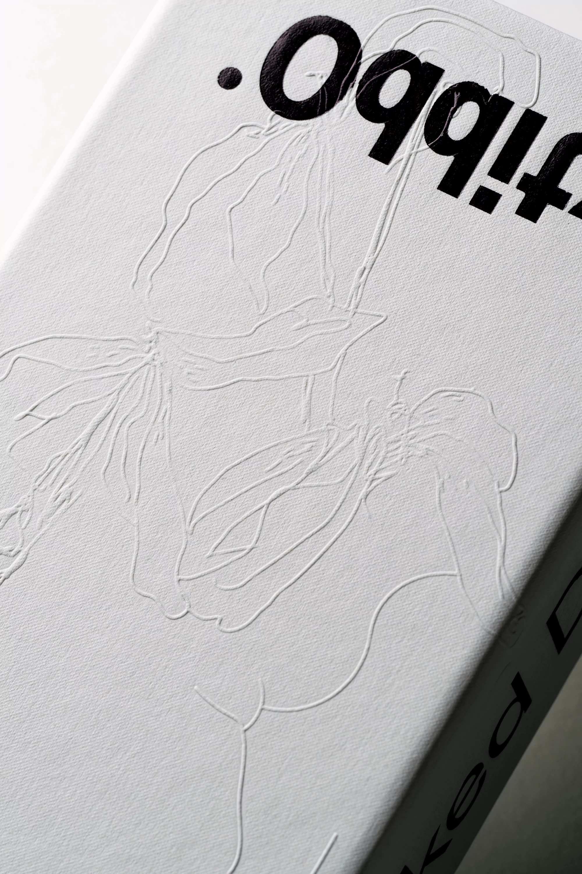 Embossed floral design on a book cover featuring bold, black lettering, set against a stark white backdrop, capturing a minimalist aesthetic.