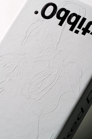 Embossed floral design on a book cover featuring bold, black lettering, set against a stark white backdrop, capturing a minimalist aesthetic.