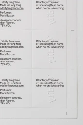 Close-up of printed product packaging layout on textured white paper with typography and embossed branding.
