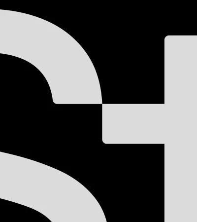 Abstract image of geometric shapes featuring a gray semicircles and rectangles against a stark black background.