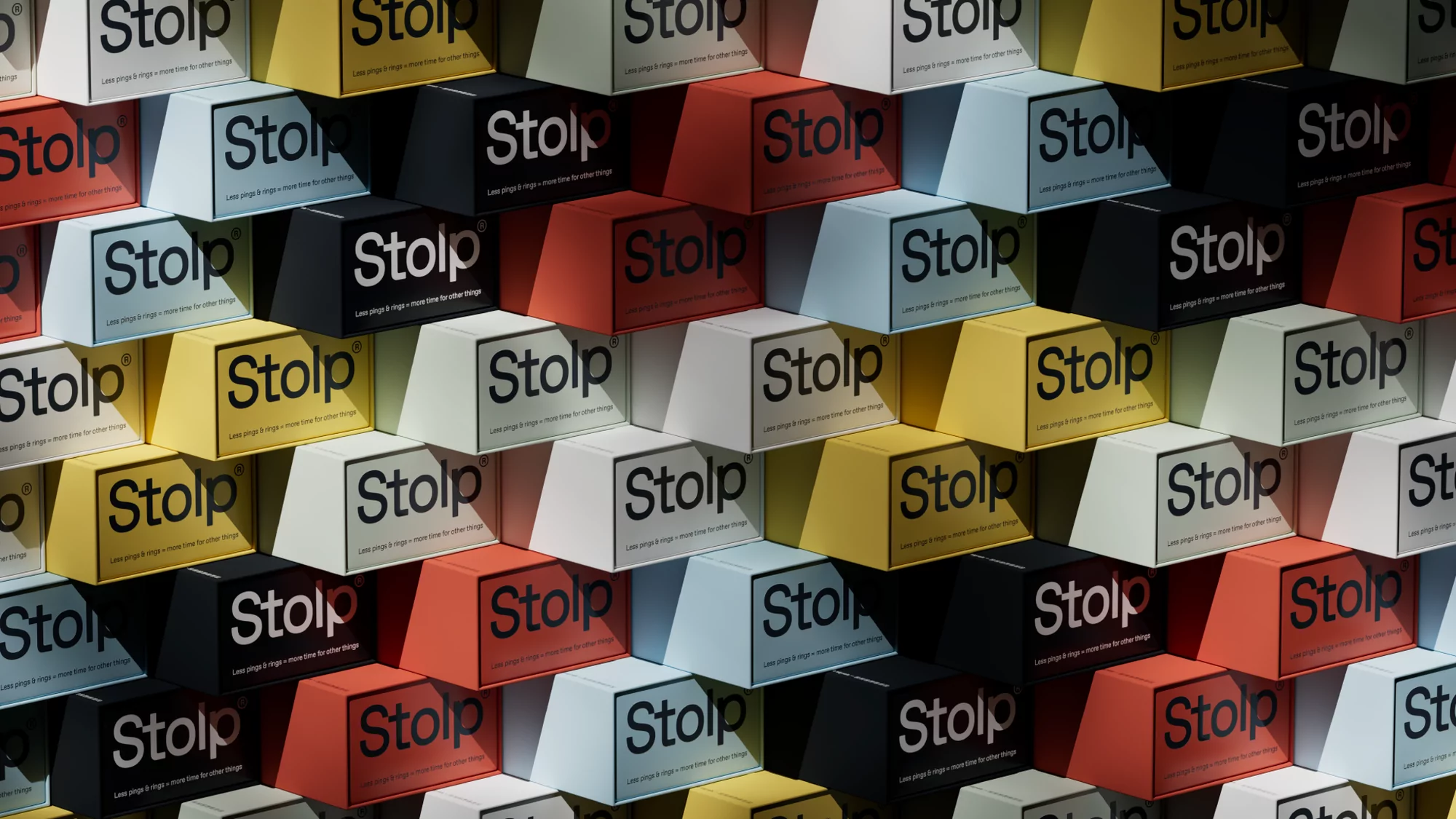 Close-up shot of a multicolored wall of Stolp branded boxes. The boxes are in various colors including yellow, white, black, and red.