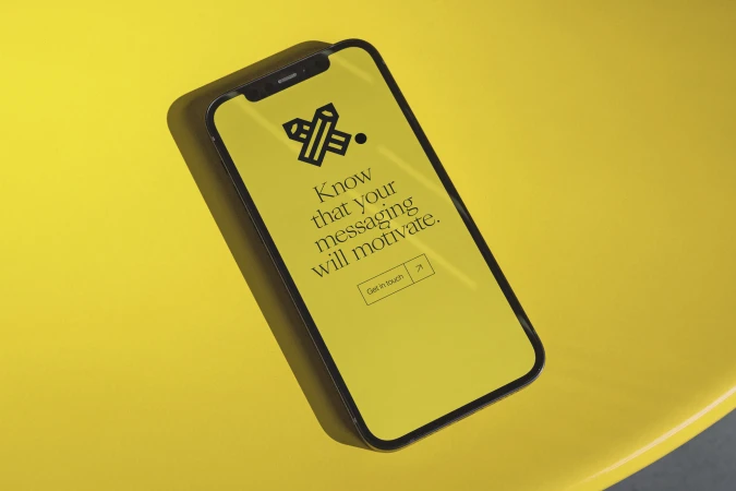 Mobile phone with yellow screen displays motivational text, placed on a yellow surface, promoting technology and communication concepts.
