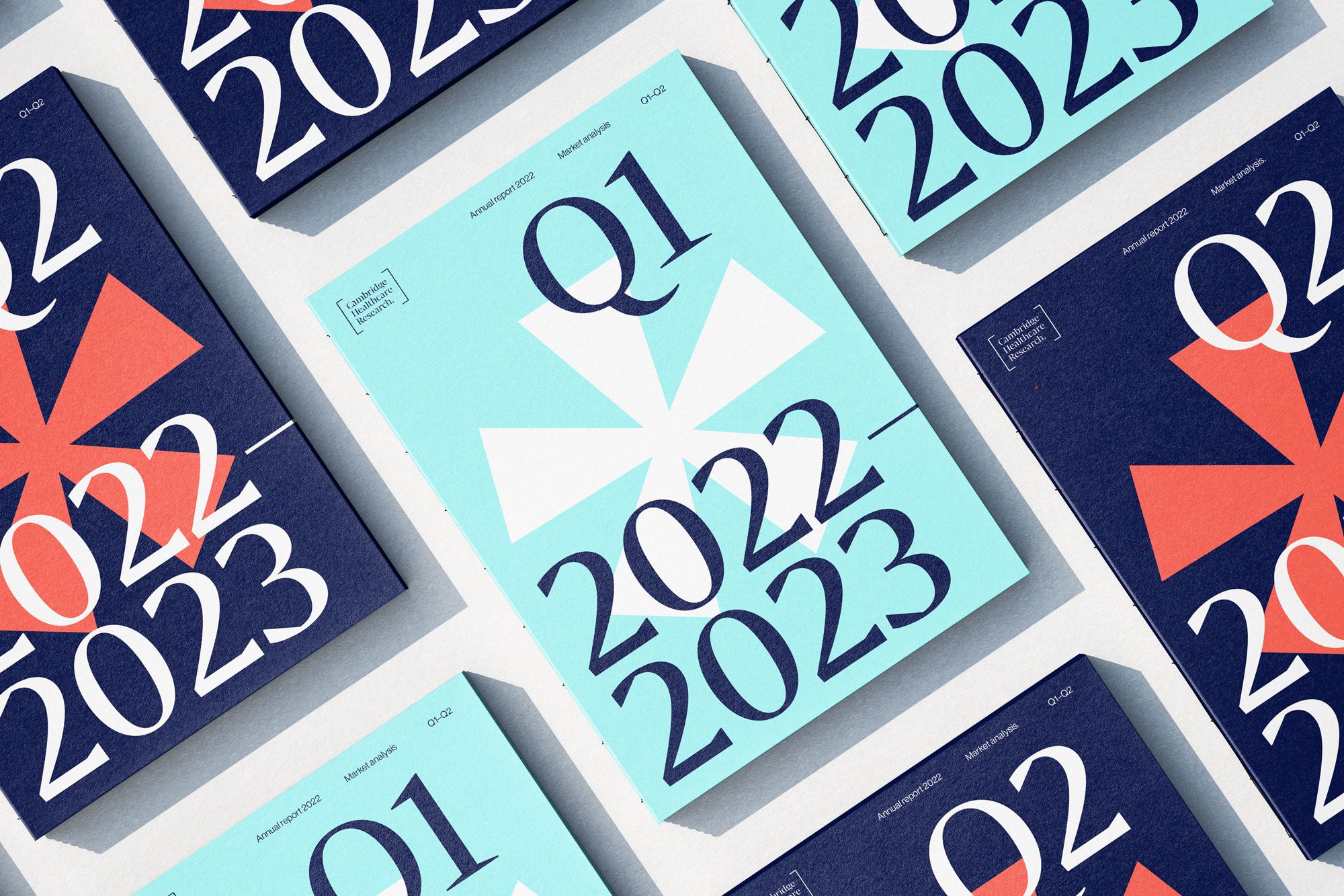 Several quarter reports for 2022 and 2023 are displayed in a flat lay with covers in blue and light blue, arranged on a white surface.