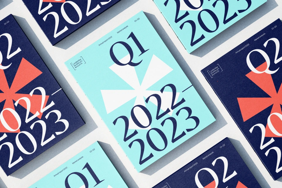 Several quarter reports for 2022 and 2023 are displayed in a flat lay with covers in blue and light blue, arranged on a white surface.