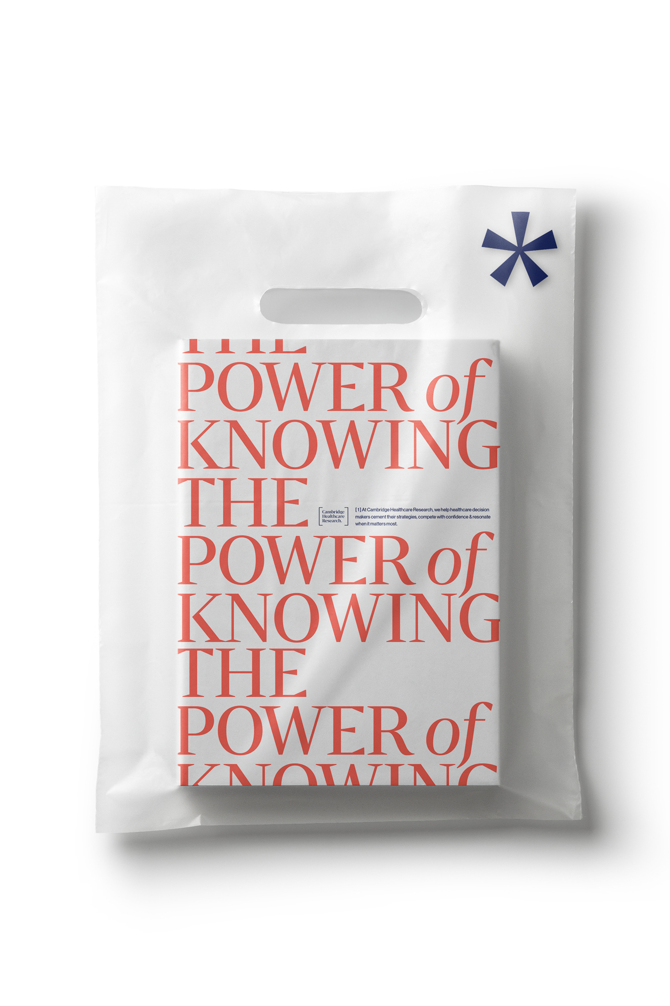 A book titled 'The Power of Knowing' inside of a white plastic shopping bag against a white backdrop. Focus on the book's design.