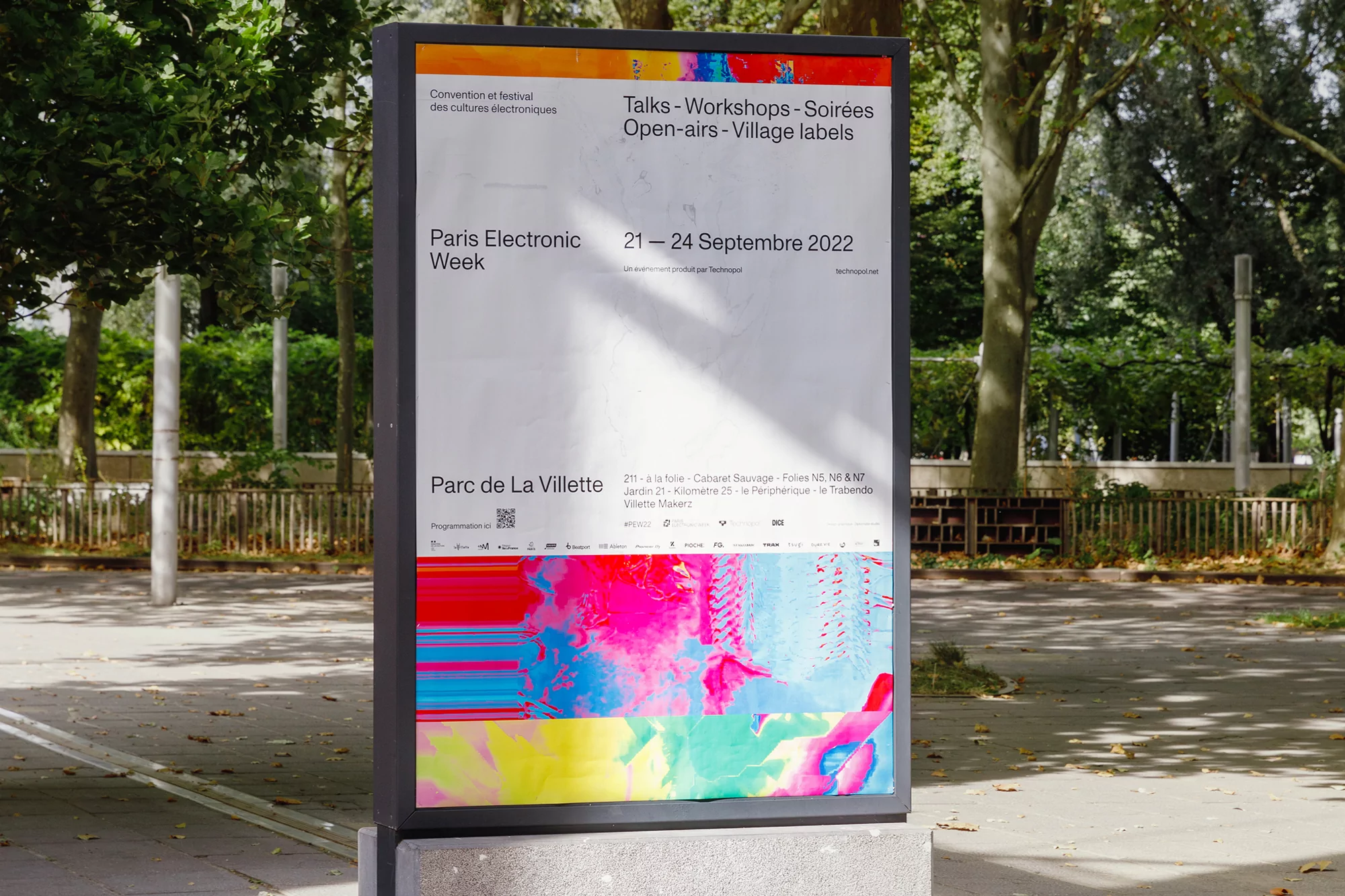 Outdoor advertising poster for the Paris Electronic Week, featuring bright color blocks and event information in an urban setting.