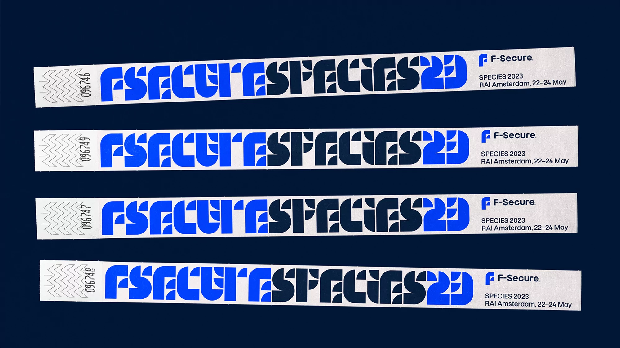 Close-up of four F-Secure Species 2023 event wristbands with event details on a dark blue background, showcasing event promotion.