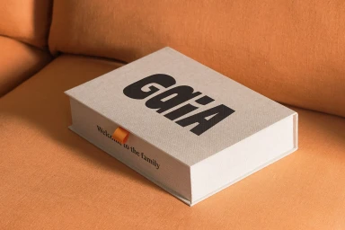 A textured light grey box with bold black text resting on an orange surface