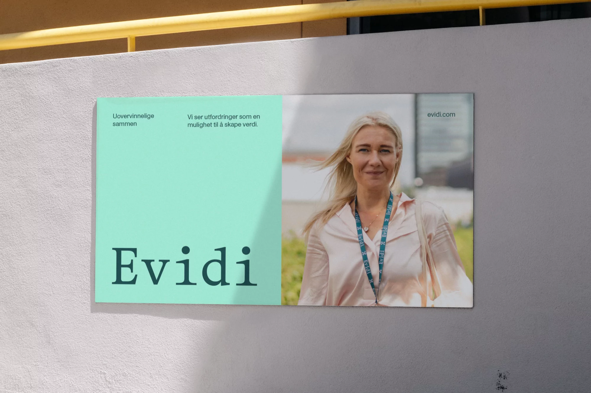 Outdoor poster featuring a fair-skinned woman with blonde hair alongside the brand name 'Evidi' and descriptive text on a sunny day.
