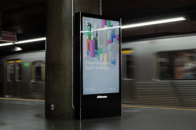 Evidi brand identity digital advertisement poster displayed on a vertical screen in a subway station with passing train motion blur.