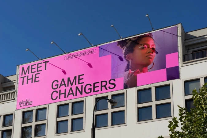 Billboard advertising campaign featuring a young Black woman's portrait with the slogan 'Meet the Game Changers' and Girls Who Code logo.
