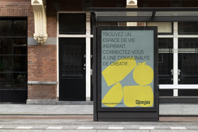 Outdoor ad in urban setting promotes collaborative workspace with abstract graphic and modern typography on bus shelter, daytime.