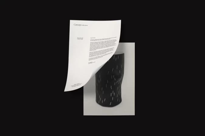 Still life of a black sculpture against a white paper and black backdrop, with the letter "Canopy Collections" at the top.