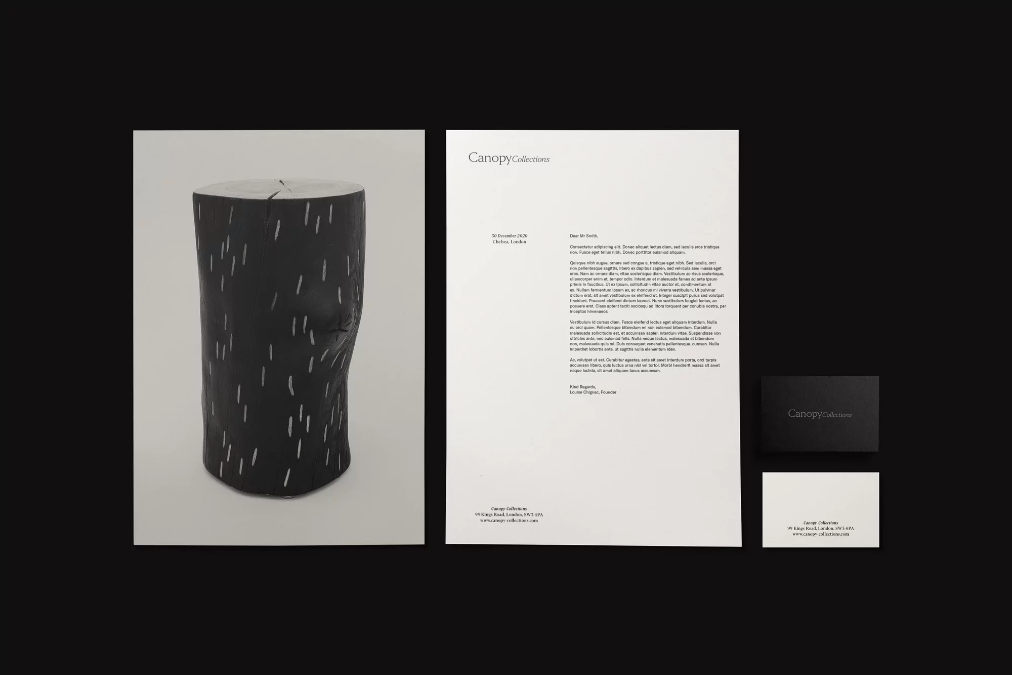 Stationery set featuring a black tree stump sculpture image and Canopy Collections letterhead and business cards on a dark backdrop.