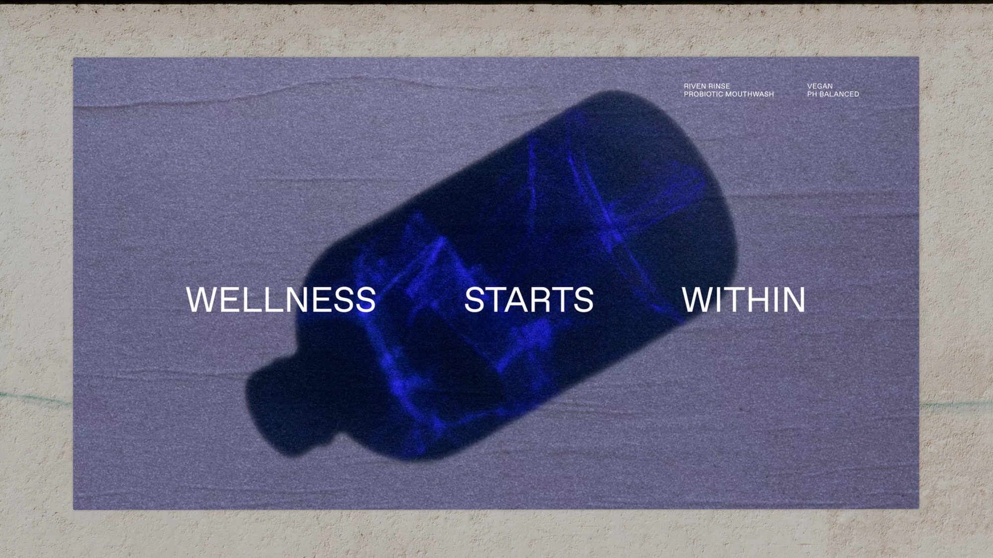 A bottle of mouthwash with the text 'Wellness Starts Within' in a stylized product shot with purple and blue color grading.