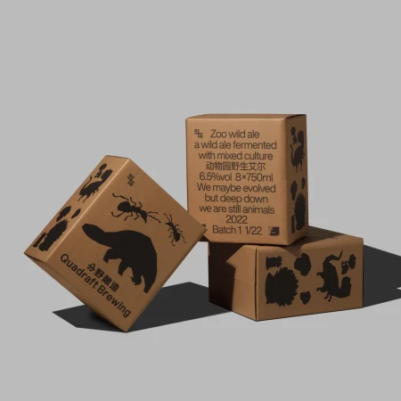 Three cardboard boxes stacked, featuring printed animal silhouettes, and Quadraft Brewing logo against a neutral background.